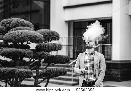 Men With Beard Smoking Electronic Cigarette Outdoor