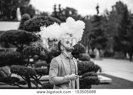 Men With Beard Smoking Electronic Cigarette Outdoor