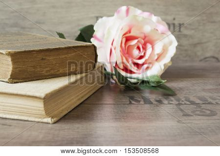 Old Books And Flower Rose On A Wooden Background. Romantic Floral Frame Background. Picture Of A Flo