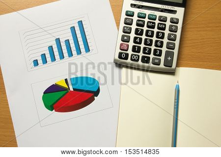 Business chart and graph with note book pen calculator