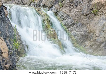 falling water in the morning mist. falling water in the dense morning fog. Water falling from a cliff. falling from a height of water. falling water in the fog. thick morning fog in the summer forest.