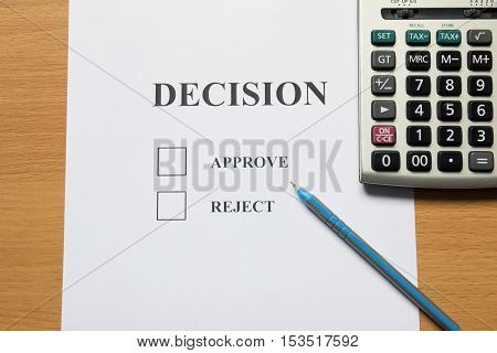 Decision paper (approve reject) with pen calculator