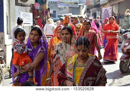 UDAIPUR, RAJASTHAN, INDIA - FEBRUARY 07, 2016 - Unidentified indian women in traditional colorful saree walking on the streets of Udaipur