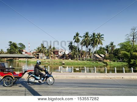 asian tuk tuk taxi on street by riverside of siem reap city cambodia