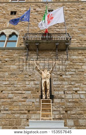 FLORENCE, ITALY - SEPTEMBER 2016 : Bronze sculpture statue of The Man Who Measures the Clouds, standing atop a ladder with ruler in Florence, Italy on September 21, 2016. By Jan Fabre, Belgian artist 