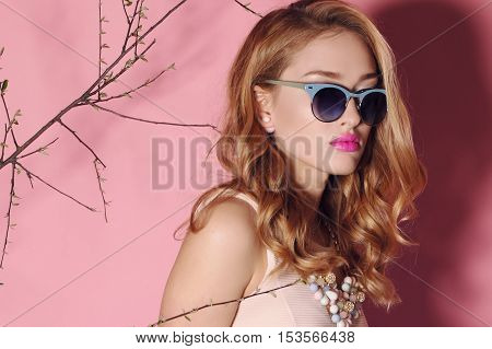 fashion studio photo of gorgeous young woman with blond hair in elegant clothes with acccessories