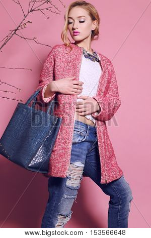 fashion studio photo of gorgeous young woman with blond hair in elegant clothes with acccessories