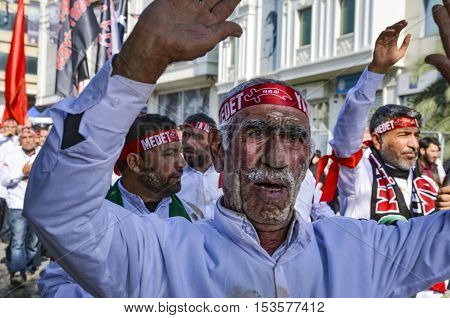 Istanbul Turkey - October 11 2016: Shia Muslim men shout Islamic slogans as they mourn during an Ashura procession. Muslims worldwide marks Ashura Istanbul Shiite community. Turkish Shia Muslims mourning for Imam Hussain. Caferis take part in a mourning p