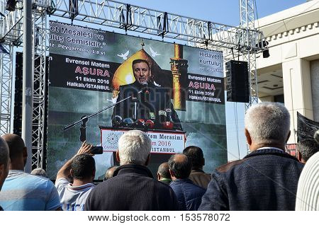Istanbul Turkey - October 11 2016: ASURE Mourning Ceremony Turkey Jafari Leader Selahattin Ozgunduz making public speeches on the big screen. Caferis take part in a mourning procession marking the day of Ashura in Istanbul's Kucukcekmece district Turkey o