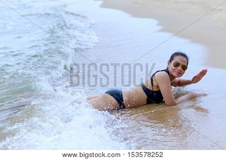 Lady happy and wave in Ban Krut Beach at Prachuap Khirikhun Province Thailand