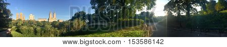 lake and Bow bridge at Central Park and the buildings with sunrise in panorama, Manhattan, New York