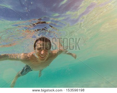 Man Swim In Clear Water