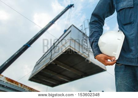 The engineering and safety helmets stood on the details of Industrial Crane operating and lifting