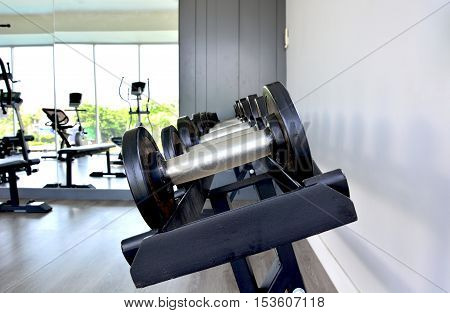 beside of dumbbells on release with white background