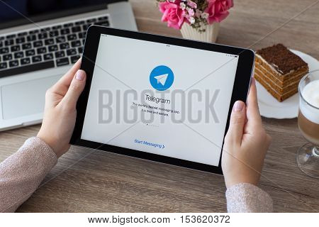 Alushta Russia - October 9 2016: Woman holding a iPad Pro Space Gray with social networking service Telegram on the screen. iPad Pro 9.7 Space Grey was created and developed by the Apple inc.