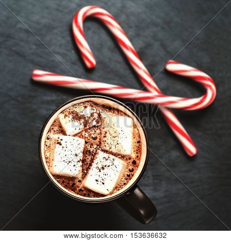 Hot Chocolate with marshmallows and candy stick traditional beverage for winter time