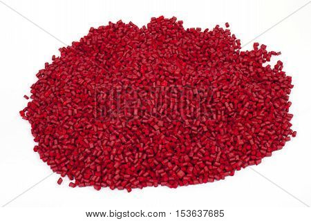 red plastic polymer granules on white background