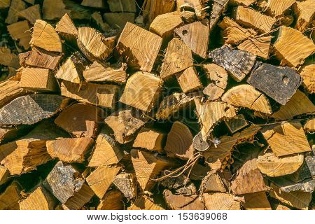 Stacked firewood cut split and seasoned at wall.