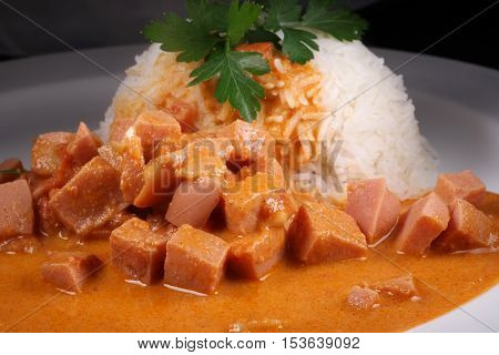 Sausage Stroganoff with rice and leaf parsley