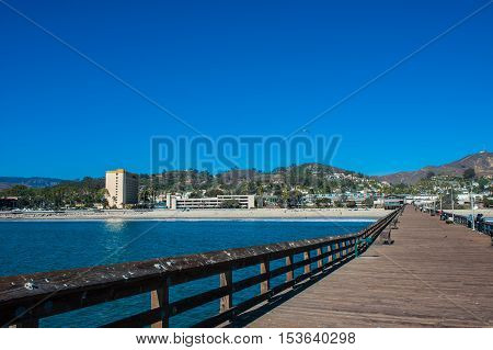 Wooden planks and vacation hotel as viewed from the Ventura Pier.