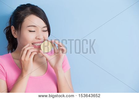 woman eating lemon feel very sour isolated on blue background