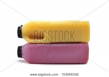 a couple of plastic bottles with a red and an orange fruit juice on a white background