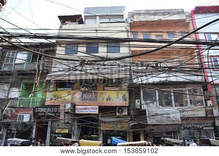 NEW DELHI, INDIA, FEBRUARY 02, 2016 - Buildings, shops and electric wires in the crowded area of Chandni Chowk in the old part of the city