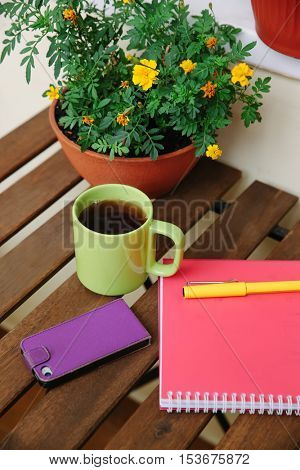 home office on the terrace, close-up, table, notebook, coffee mug