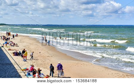 Zelenograd Russia - July 16 2016: Crowd of people on a beach of Zelenograd. Curonian spit Kaliningrad region. Russia