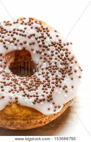 Closeup of fresh donut decorated with chocolate