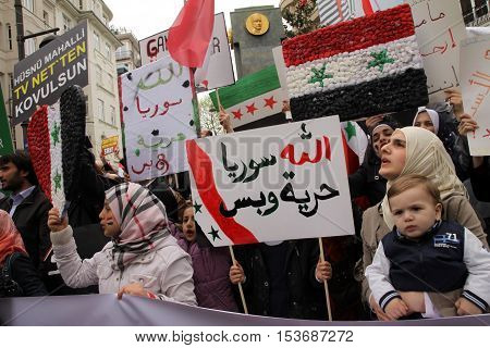 ISTANBUL,TURKEY-DECEMBER 2: Unidentified Syrians living in Istanbul protest the regime of Bashar Essad in front of Syrian Consulate on December 2, 2011 in Istanbul,Turkey.