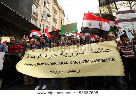ISTANBUL,TURKEY-DECEMBER 2: Unidentified Syrians living in Istanbul protest the regime of Bashar Essad in front of Syrian Consulate on December 2, 2011 in Istanbul,Turkey.