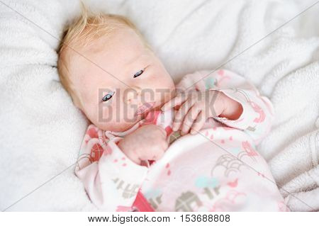 Adorable newborn baby girl portrait at home