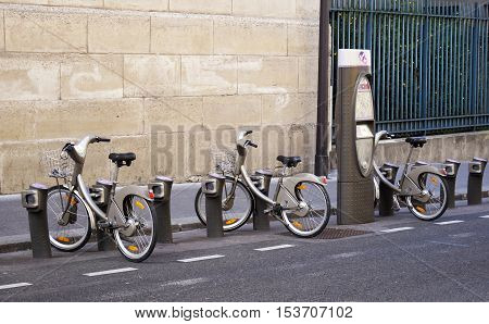 PARIS FRANCE - SEPTEMBER 27 2015: Bicycles parked at Velib station in Paris France