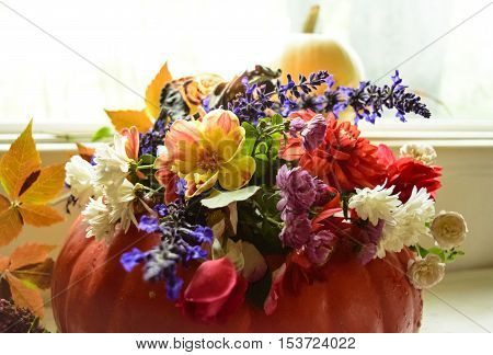 Beautiful Pumpkin Centerpiece with an abundance of autumn flowers and roses