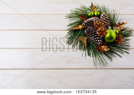 Christmas background with holiday golden cones decorated wreath. Christmas decoration with golden decor. Christmas greeting background.