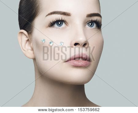 Fashion Beautiful Woman With Drops Of Gel On Another Cheek