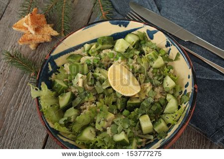 vegan healthy salad with bulgur, cucumber, avocado and crispy toast