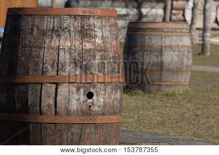 two wooden wine barrels kegs in a row outside cellar