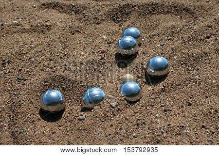 the Petanque balls on sandy close to