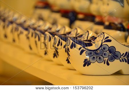 White and blue ceramic Dutch shoes on shelf