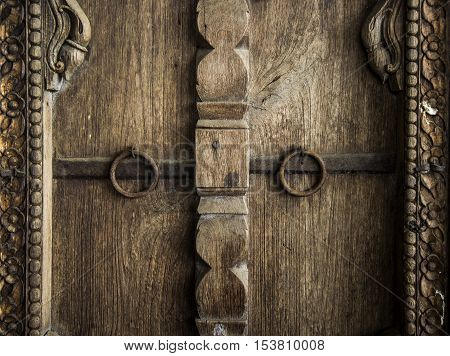 Antique old door made of wood with metal door handles