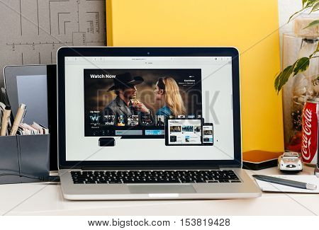PARIS FRANCE - OCT 28 2016: Apple Computers website on new MacBook Pro Retina with OLED touch bar in a geek creative room showcasing the new TV app from apple with the Watch Now function on all Apple devices