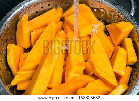 Pumpkin sliced under water. Selective focus.Blurry over water