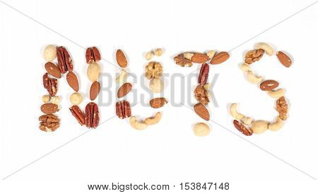 Nuts sign made of different nut seeds on white background