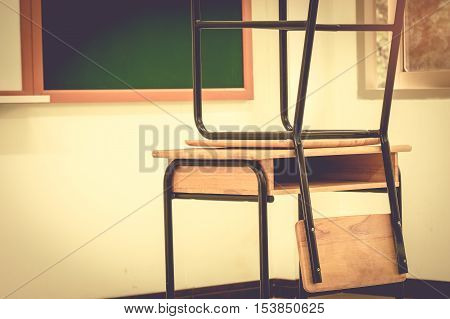 School classroom with desks wood chalkboard and whiteboard in high school vintage stlye