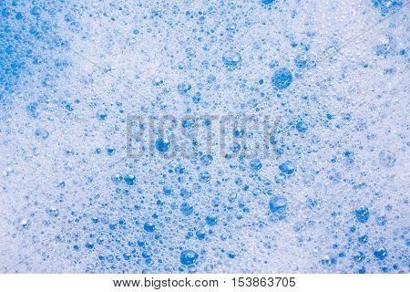 Abstract background of soap foam, suds, shower. Blue background. soft focus, macro view
