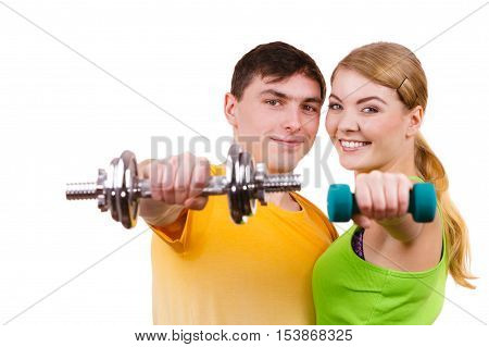 Couple fit woman and strong man exercising with dumbbells. Muscular guy and fitness blonde girl lifting weights. Bodybuilding.
