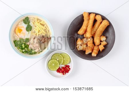 Rice porridge with mined pork and chicken lever served with side dish as Patongko (deep-fried dough stick) and spicy sour fillin.