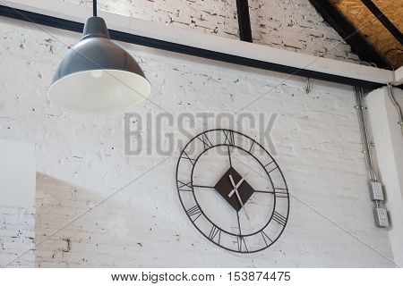 White room with ceiling lamp and clock stock photo